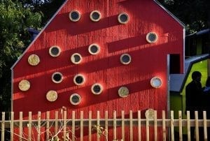 Red shed exterior. Circular windows added all over shed wall.