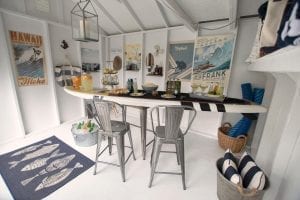 Pool shed interior. Table shaped like surf board with food on top.