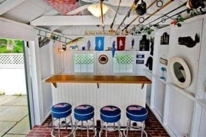 Bar shed: Wood counter top and four blue bar stools.